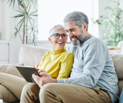 Elderly couple looking at laptop 